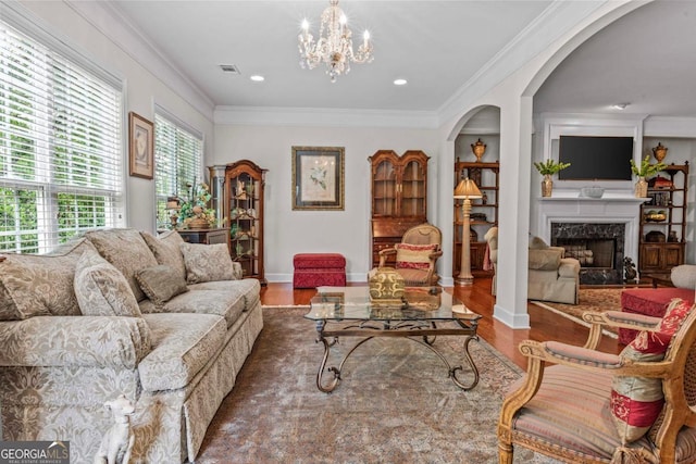 1000 Deep Water Way, Greensboro, GA 30642 - living room featuring arched walkways, wood finished floors, ornamental molding, a high end fireplace, and a chandelier