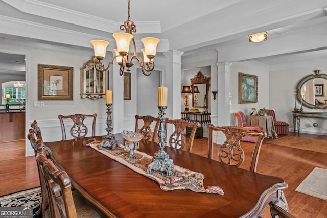 1000 Deep Water Way, Greensboro, GA 30642 - dining space with wood finished floors, a chandelier, crown molding, and decorative columns