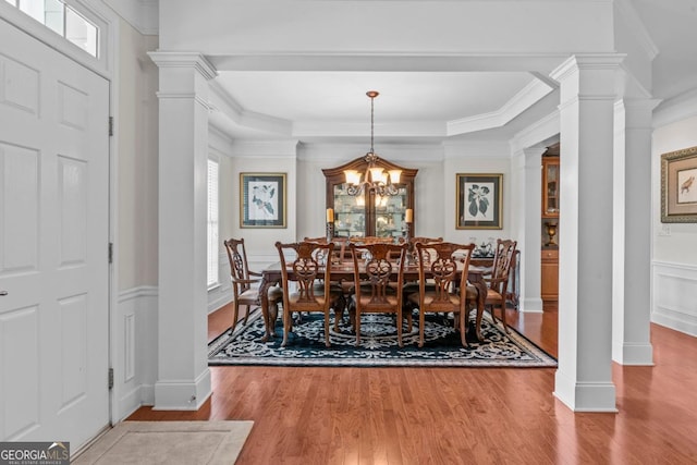 1000 Deep Water Way, Greensboro, GA 30642 - dining space featuring wood finished floors, crown molding, decorative columns, a wainscoted wall, and a chandelier