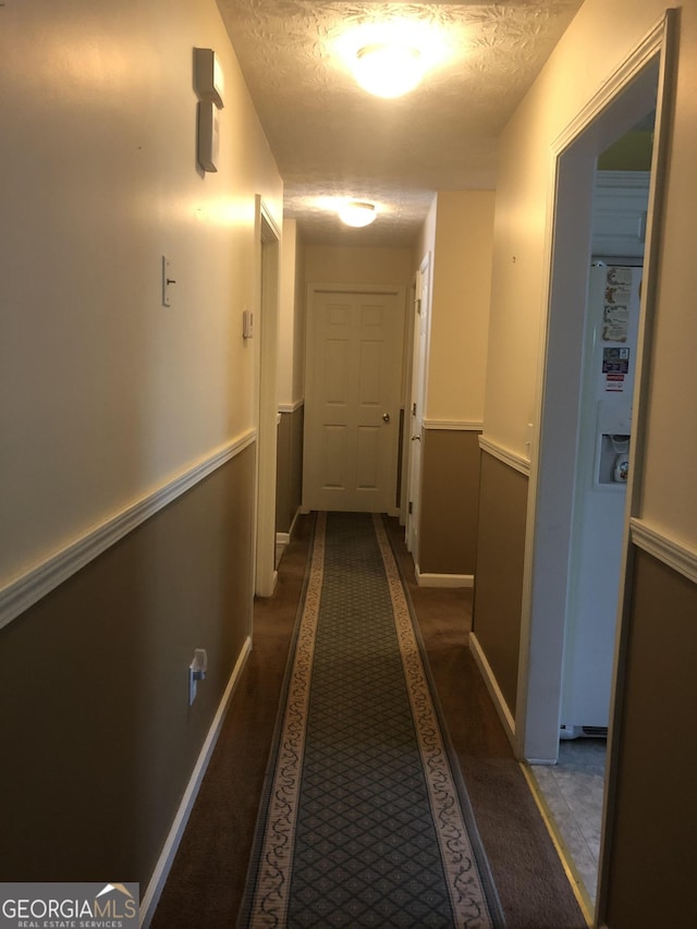 1744 Campbell Rd, Covington, GA 30014 - corridor with a textured ceiling, baseboards, and carpet