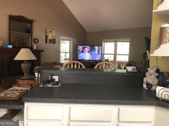1744 Campbell Rd, Covington, GA 30014 - kitchen featuring white cabinetry, lofted ceiling, and dark countertops