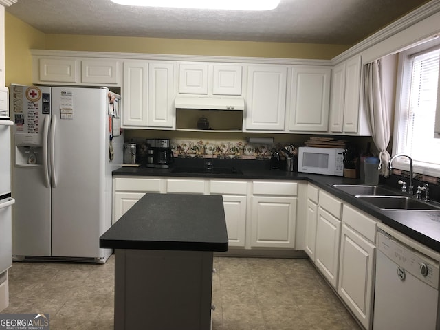 1744 Campbell Rd, Covington, GA 30014 - kitchen with white appliances, a sink, white cabinets, dark countertops, and a kitchen island