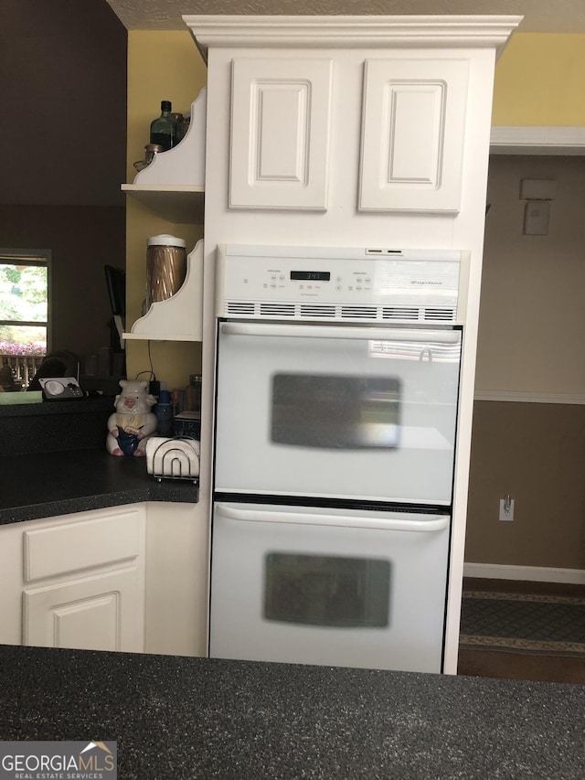 1744 Campbell Rd, Covington, GA 30014 - kitchen featuring double oven, dark countertops, white cabinets, and open shelves