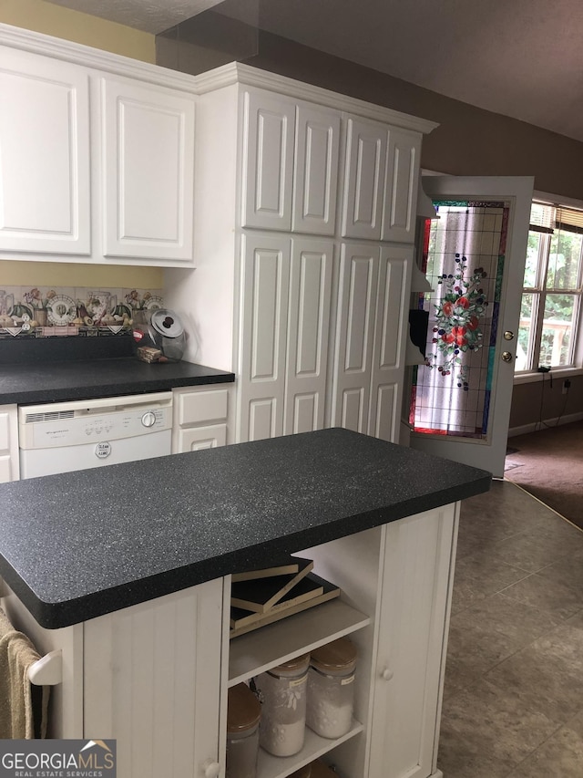 1744 Campbell Rd, Covington, GA 30014 - kitchen featuring white dishwasher, white cabinetry, and dark countertops