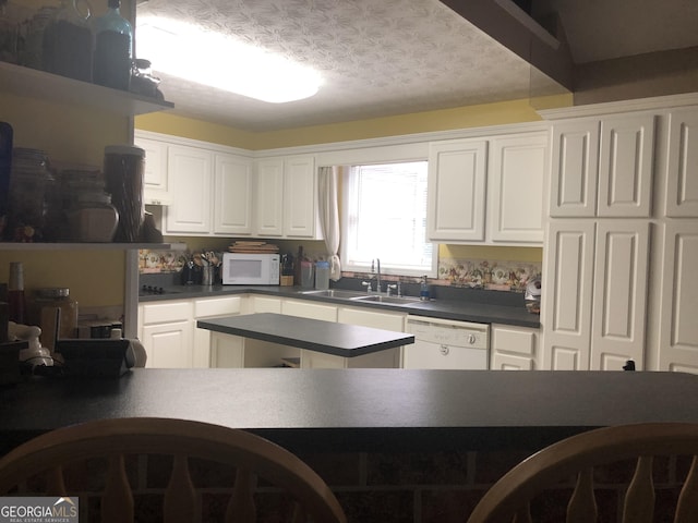 1744 Campbell Rd, Covington, GA 30014 - kitchen with white appliances, a sink, dark countertops, and white cabinets