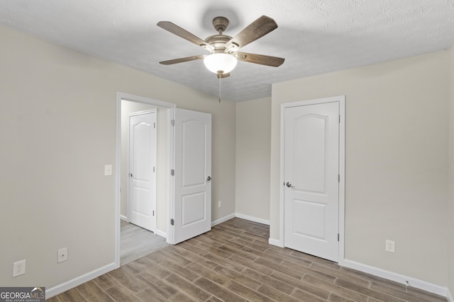 165 Heaton Place Trl, Covington, GA 30016 - unfurnished bedroom with wood finished floors, baseboards, and ceiling fan