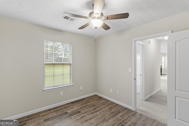 165 Heaton Place Trl, Covington, GA 30016 - spare room featuring wood finished floors, a ceiling fan, baseboards, and a textured ceiling