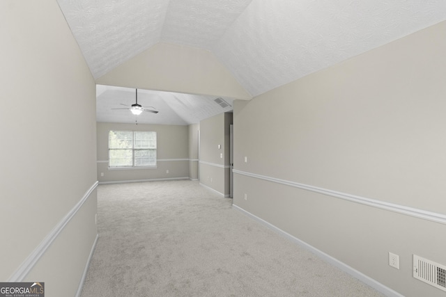 165 Heaton Place Trl, Covington, GA 30016 - spare room with lofted ceiling, a textured ceiling, carpet, baseboards, and ceiling fan