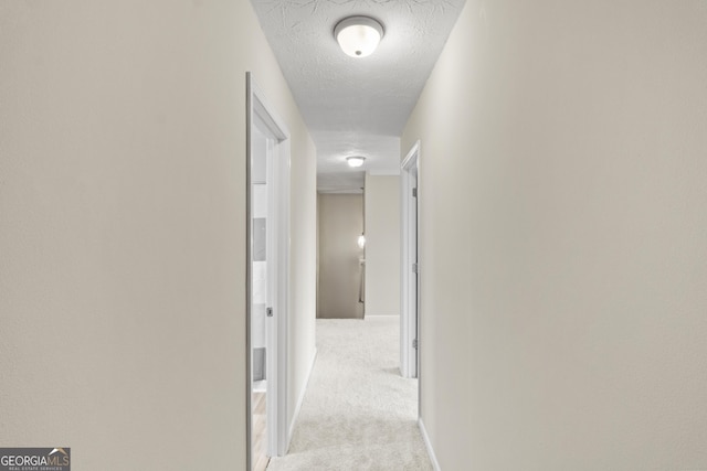 165 Heaton Place Trl, Covington, GA 30016 - hall featuring carpet floors, a textured ceiling, and baseboards