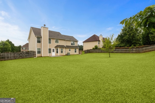 165 Heaton Place Trl, Covington, GA 30016 - rear view of house with central air condition unit, a chimney, and a patio area