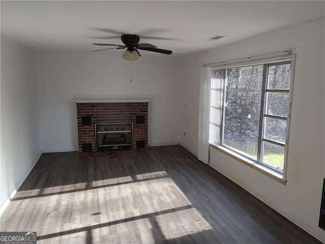 4076 Fairmont St, Gainesville, GA 30506 - unfurnished living room with healthy amount of natural light, wood finished floors, ceiling fan, and a brick fireplace