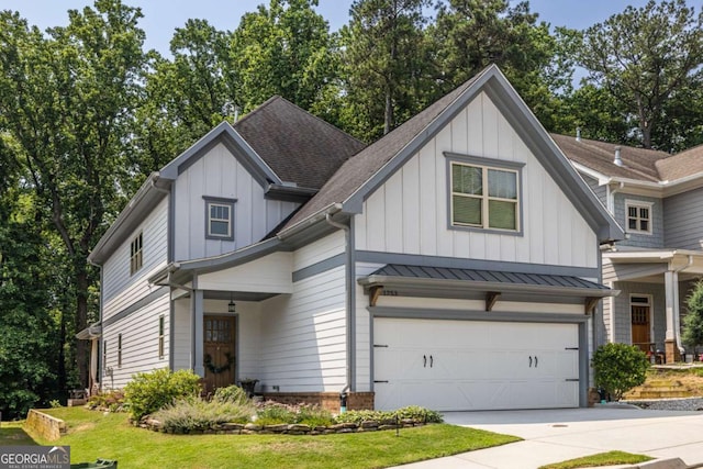 1753 Russell St SE, Atlanta, GA 30316 - view of front of home with board and batten siding, a shingled roof, concrete driveway, and an attached garage