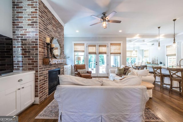 1753 Russell St SE, Atlanta, GA 30316 - living room featuring ornamental molding, plenty of natural light, a ceiling fan, dark wood finished floors, and a fireplace
