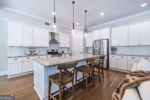 1753 Russell St SE, Atlanta, GA 30316 - kitchen with stainless steel appliances, wall chimney range hood, white cabinets, dark wood finished floors, and crown molding