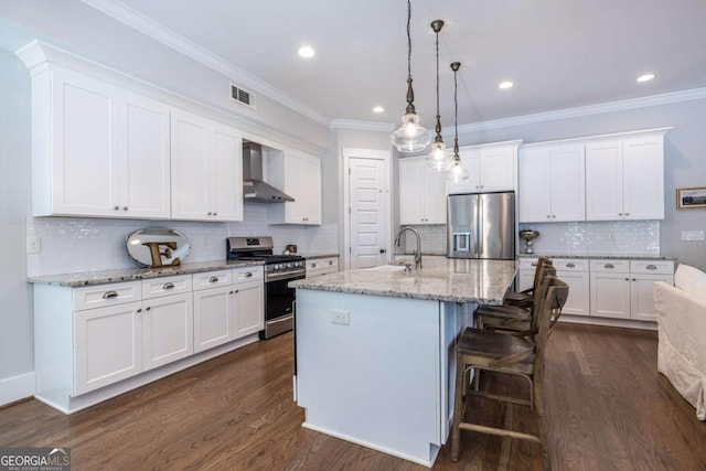 1753 Russell St SE, Atlanta, GA 30316 - kitchen featuring stainless steel appliances, wall chimney exhaust hood, tasteful backsplash, white cabinets, and dark wood-type flooring