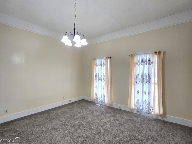 35 Cheatham St, Wadley, GA 30477 - empty room featuring a chandelier, dark colored carpet, crown molding, and baseboards