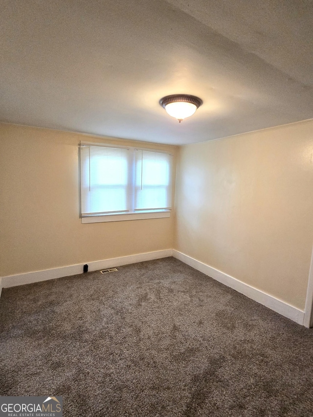 35 Cheatham St, Wadley, GA 30477 - spare room featuring dark carpet and baseboards