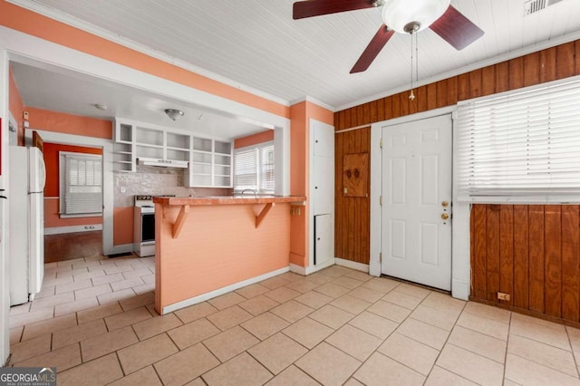3956 Tell Rd SW, Atlanta, GA 30331 - kitchen featuring white appliances, ceiling fan, a kitchen bar, light tile patterned floors, and under cabinet range hood