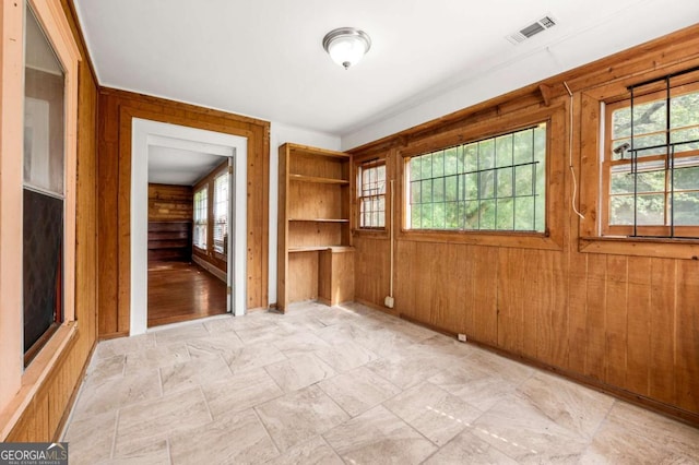 3956 Tell Rd SW, Atlanta, GA 30331 - empty room with wood walls and light stone finish floors