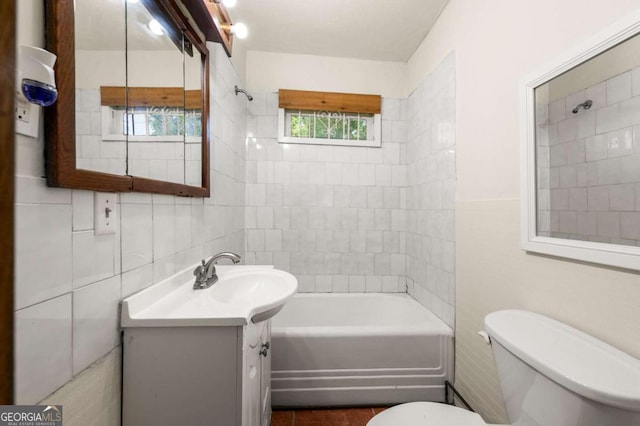 3956 Tell Rd SW, Atlanta, GA 30331 - bathroom featuring vanity, tile walls, and bathing tub / shower combination