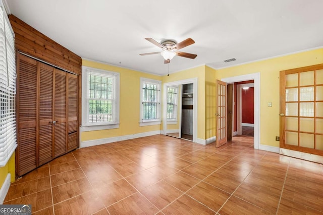 3956 Tell Rd SW, Atlanta, GA 30331 - unfurnished bedroom with multiple closets, crown molding, ceiling fan, and tile patterned flooring