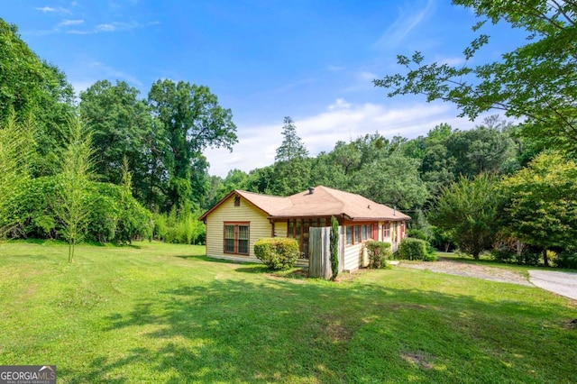 3956 Tell Rd SW, Atlanta, GA 30331 - view of front of property with a front lawn, driveway, and a forest view