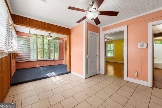 3956 Tell Rd SW, Atlanta, GA 30331 - unfurnished room with a ceiling fan, crown molding, light tile patterned floors, and wooden walls