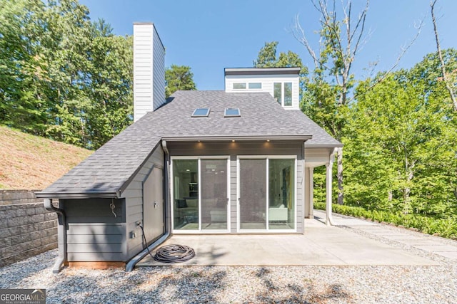 85 Lila Way, Dahlonega, GA 30533 - rear view of property featuring a chimney, a shingled roof, and a patio area