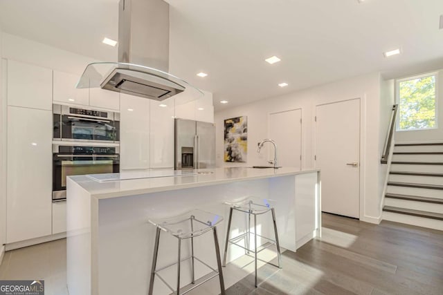 85 Lila Way, Dahlonega, GA 30533 - kitchen featuring stainless steel appliances, modern cabinets, island exhaust hood, white cabinets, and recessed lighting