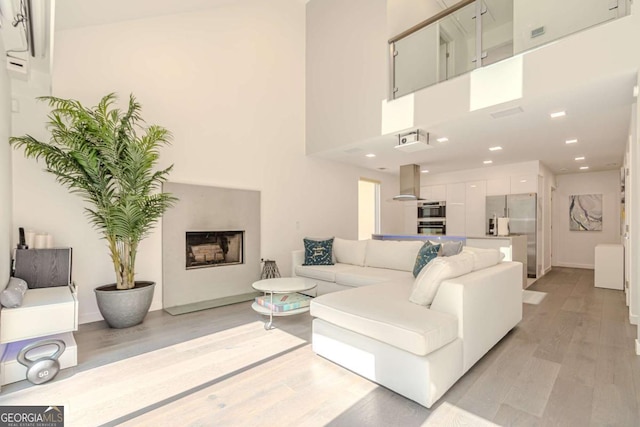 85 Lila Way, Dahlonega, GA 30533 - living area with light wood finished floors, baseboards, a fireplace, recessed lighting, and a towering ceiling
