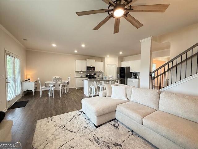 5996 Screech Owl Dr, Flowery Branch, GA 30542 - living room featuring crown molding, ceiling fan, stairs, recessed lighting, and dark wood finished floors