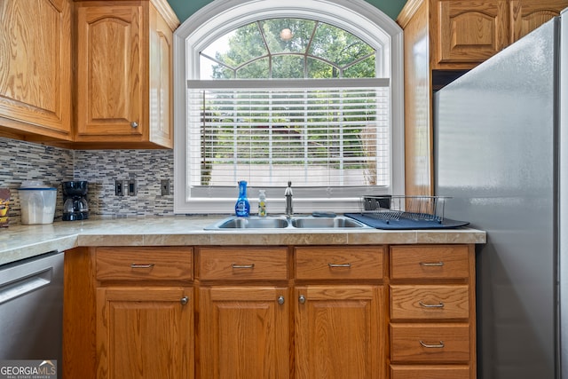 894 Oak Pointe Dr, Cleveland, GA 30528 - kitchen with appliances with stainless steel finishes, a sink, light countertops, backsplash, and brown cabinetry