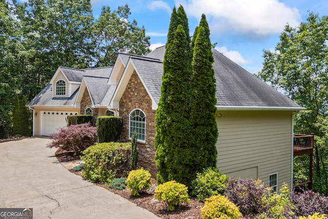 894 Oak Pointe Dr, Cleveland, GA 30528 - view of home's exterior featuring stone siding, concrete driveway, a garage, and a shingled roof