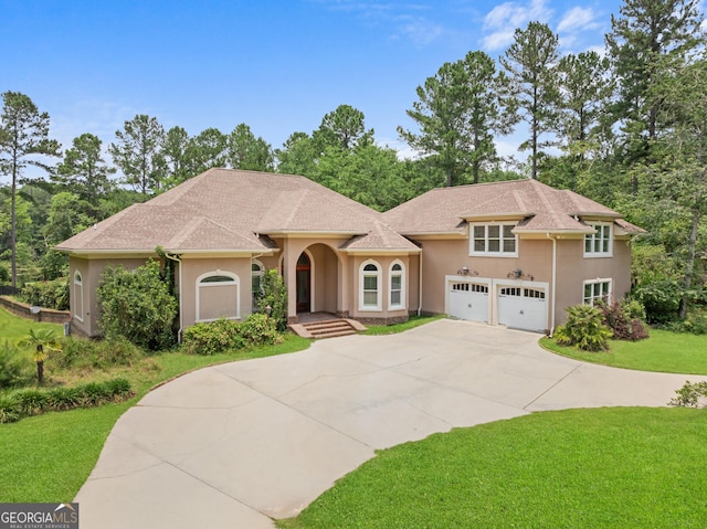 353 Indigo Hills Rd, Pembroke, GA 31321 - mediterranean / spanish-style house featuring stucco siding, driveway, and a front lawn