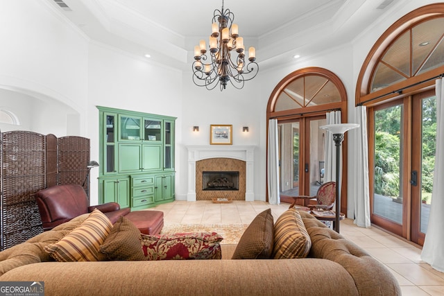 353 Indigo Hills Rd, Pembroke, GA 31321 - living room with light tile patterned floors, a chandelier, ornamental molding, a high ceiling, and a fireplace