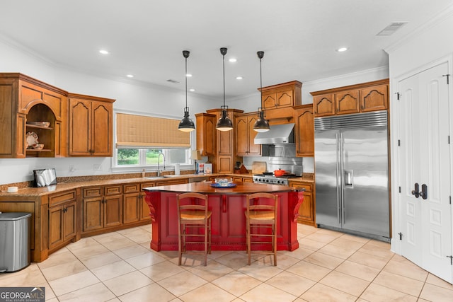 353 Indigo Hills Rd, Pembroke, GA 31321 - kitchen featuring stainless steel built in refrigerator, a center island, wall chimney exhaust hood, a sink, and brown cabinets