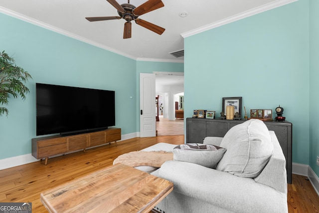 353 Indigo Hills Rd, Pembroke, GA 31321 - living room with ornamental molding, a ceiling fan, baseboards, and wood finished floors