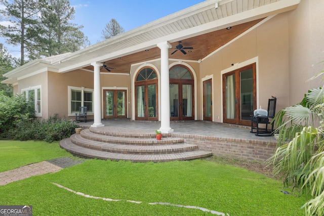 353 Indigo Hills Rd, Pembroke, GA 31321 - back of property featuring french doors, a ceiling fan, stucco siding, a lawn, and a patio area
