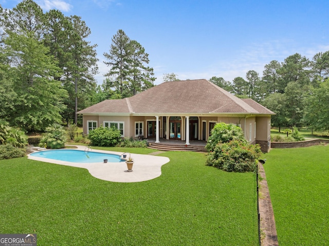 353 Indigo Hills Rd, Pembroke, GA 31321 - rear view of house with a yard, stucco siding, an outdoor pool, and a patio area