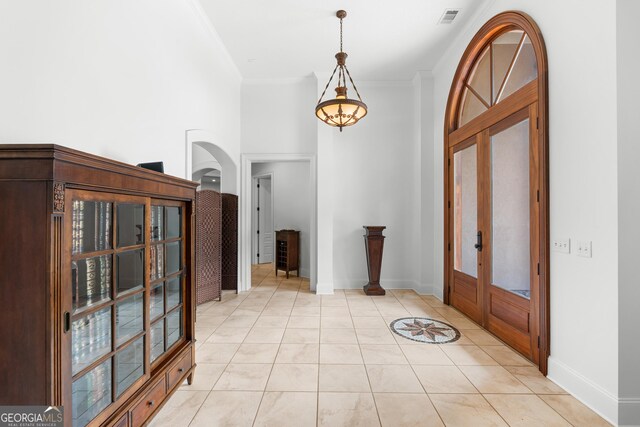 353 Indigo Hills Rd, Pembroke, GA 31321 - foyer with light tile patterned floors, french doors, arched walkways, baseboards, and ornamental molding