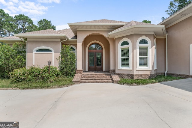 353 Indigo Hills Rd, Pembroke, GA 31321 - view of exterior entry featuring stucco siding and french doors