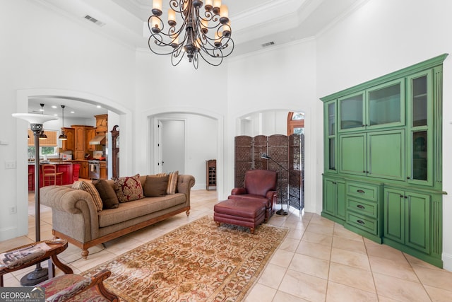 353 Indigo Hills Rd, Pembroke, GA 31321 - living room with arched walkways, ornamental molding, a high ceiling, a chandelier, and light tile patterned flooring
