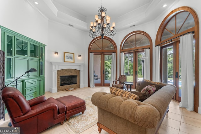 353 Indigo Hills Rd, Pembroke, GA 31321 - living area with light tile patterned flooring, healthy amount of natural light, a chandelier, ornamental molding, and a towering ceiling