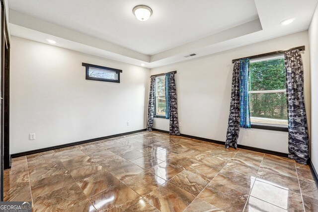 2711 Mcdonough Rd, Hampton, GA 30228 - spare room featuring healthy amount of natural light, marble tiled floors, baseboards, a raised ceiling, and recessed lighting