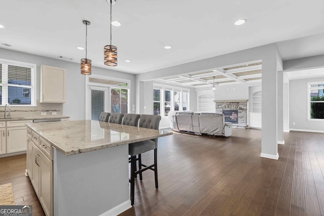 2029 Havenhurst Way, Auburn, GA 30011 - kitchen with a sink, a breakfast bar, recessed lighting, open floor plan, and a kitchen island
