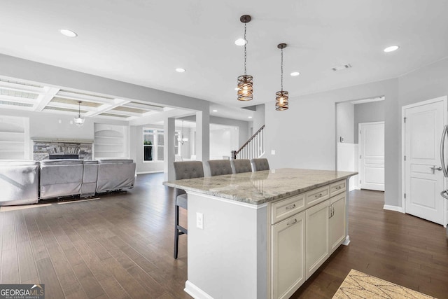 2029 Havenhurst Way, Auburn, GA 30011 - kitchen with open floor plan, dark wood-type flooring, a breakfast bar area, recessed lighting, and hanging light fixtures