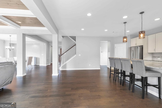 2029 Havenhurst Way, Auburn, GA 30011 - kitchen featuring freestanding refrigerator, baseboards, open floor plan, recessed lighting, and a kitchen bar