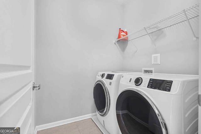 2029 Havenhurst Way, Auburn, GA 30011 - laundry area featuring washer and clothes dryer, baseboards, and light tile patterned flooring