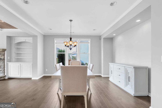 2029 Havenhurst Way, Auburn, GA 30011 - dining space with a chandelier, crown molding, dark wood-style flooring, baseboards, and built in features