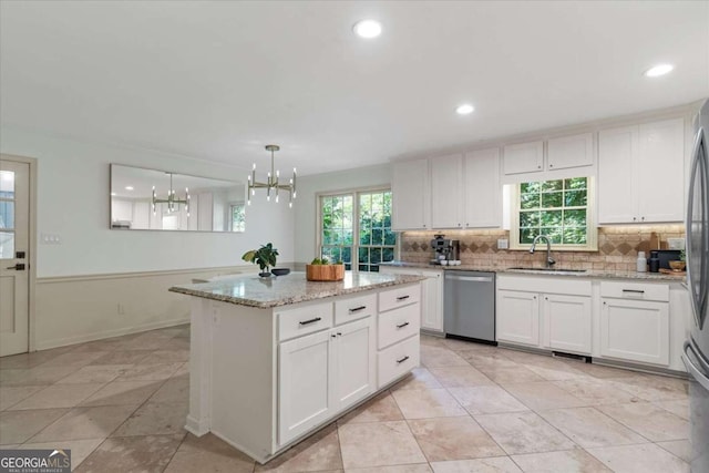 11785 Mountain Laurel Dr, Roswell, GA 30075 - kitchen featuring dishwasher, a chandelier, tasteful backsplash, white cabinets, and a kitchen island